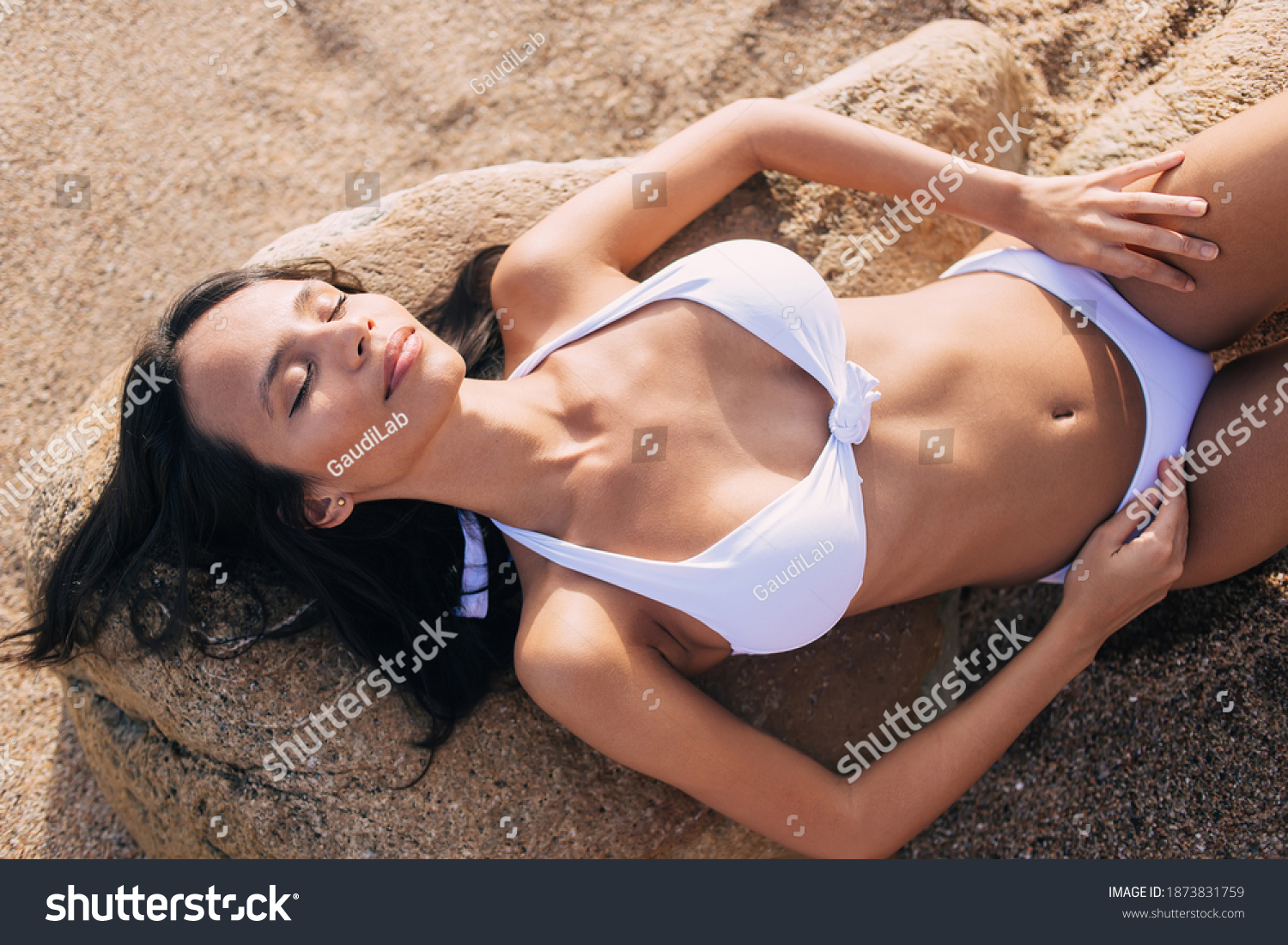 Pretty amateur girl takes off bikini on a beach