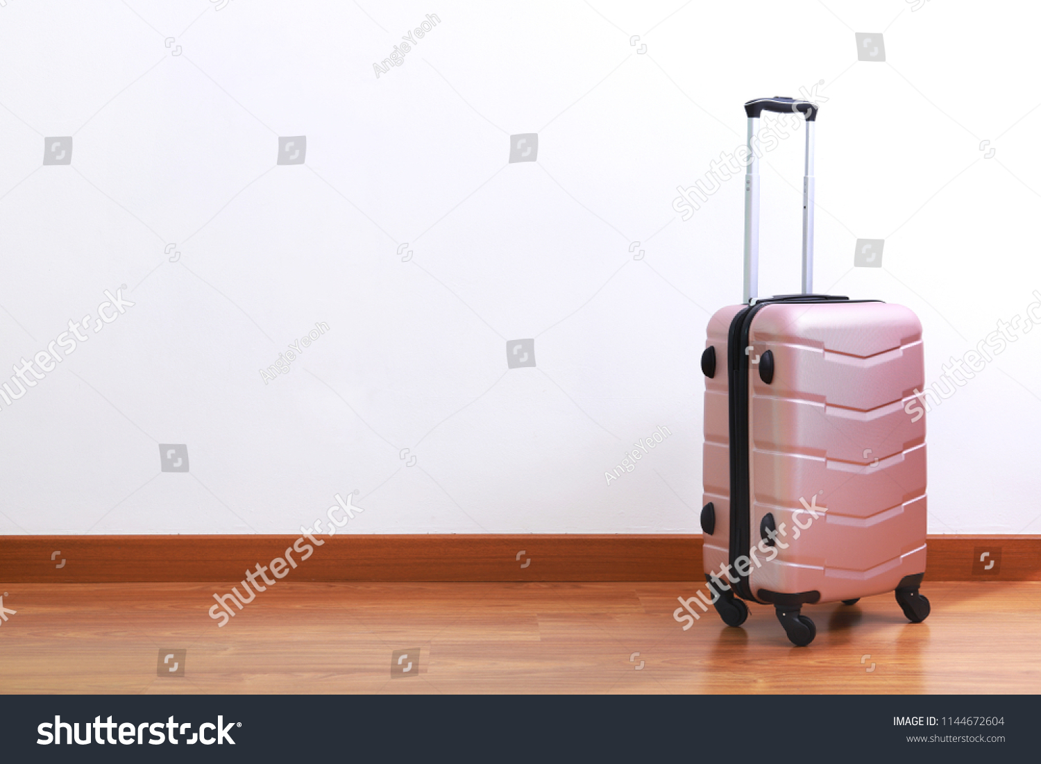 light pink suitcase