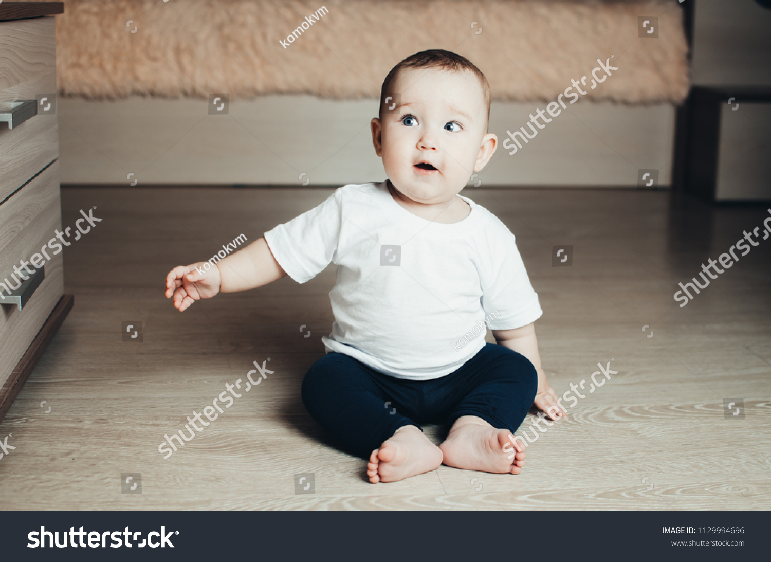 Little Baby Girl Sitting On Floor Stock Photo 1129994696 | Shutterstock