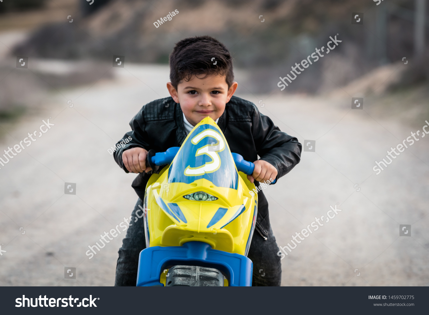 little boy riding motorcycle