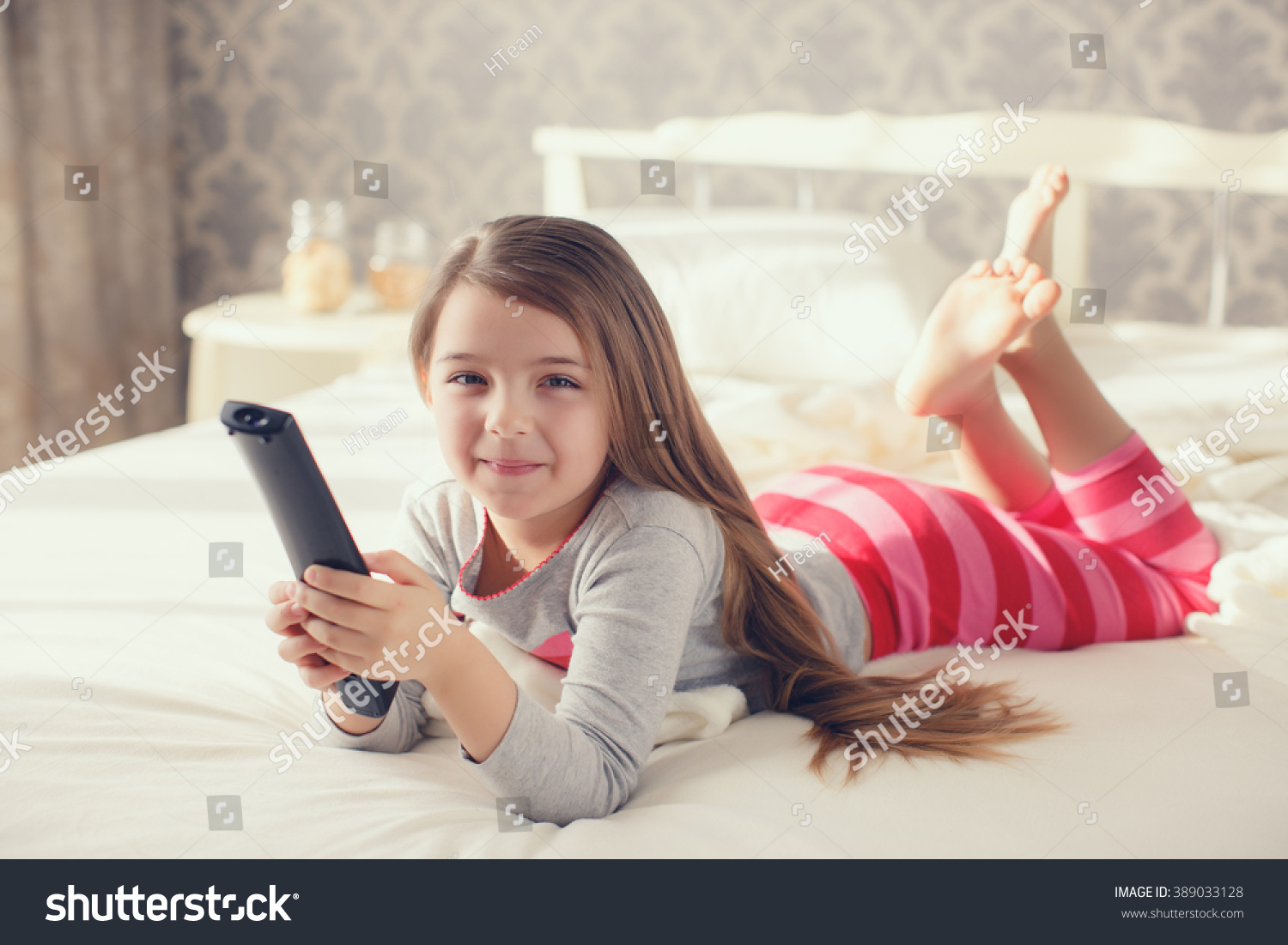 Little Girl Child Remote Control Watching  Stock Photo Edit Now 389033128 Shutterstock