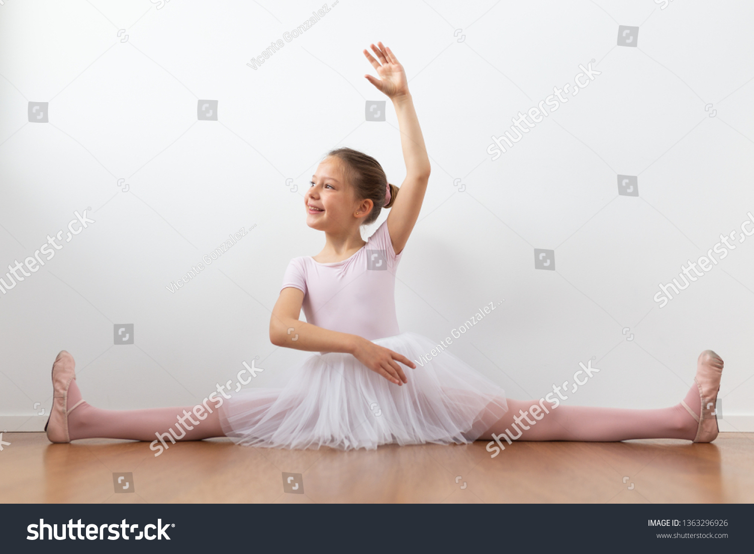 toddler girl open legs Little girl in cap sits on floor with legs spread apart and ...