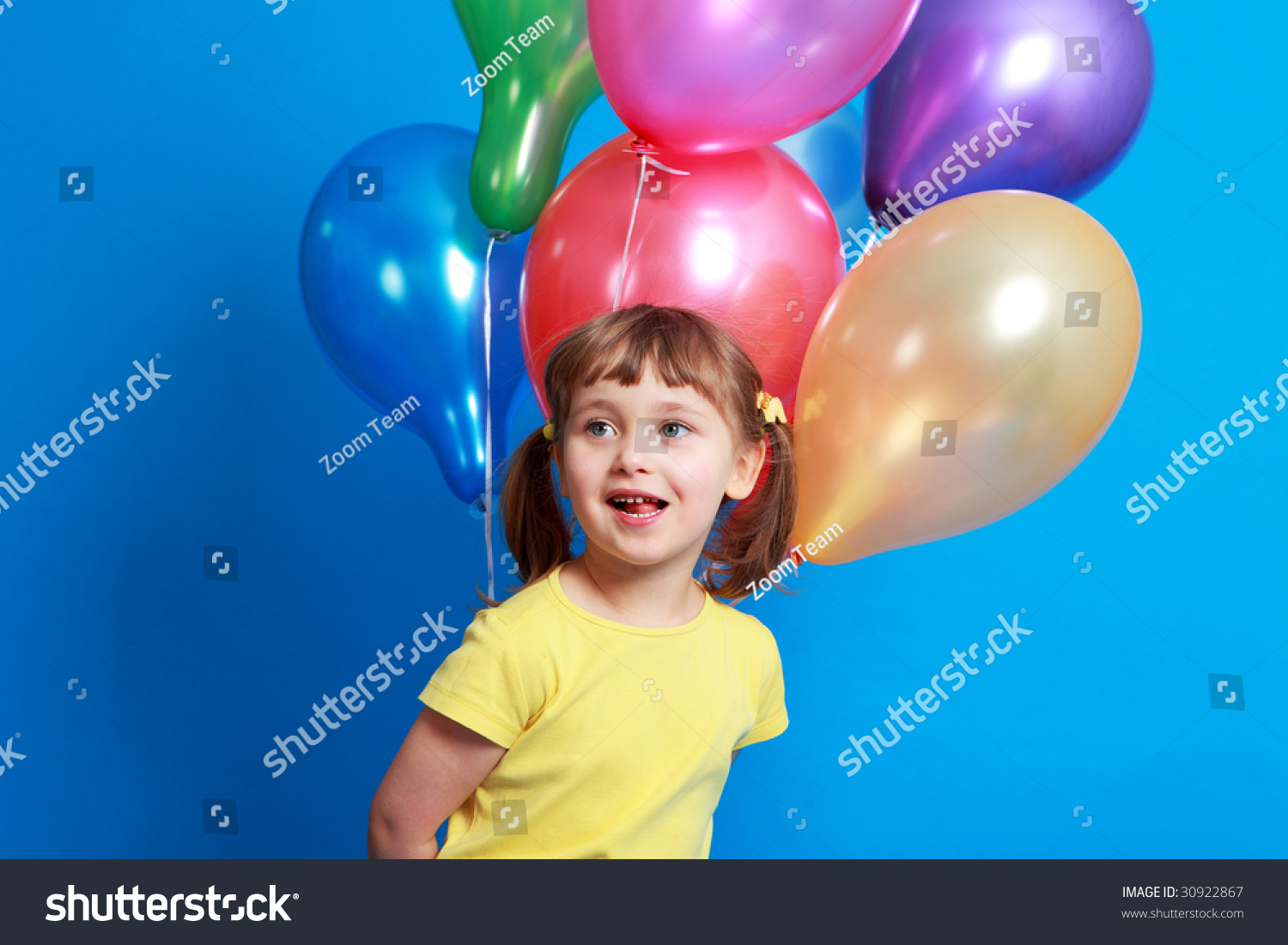 Little Girl Holding Colorful Balloons On A Blue Background Stock Photo ...