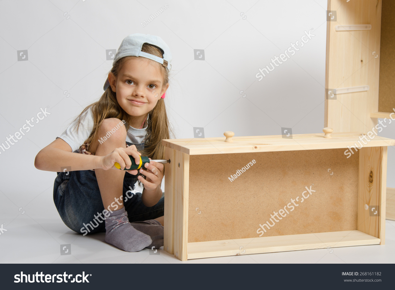 Little Girl Overalls Collector Collects Furniture Stock Photo