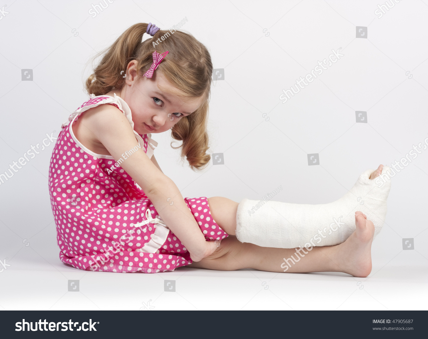 Little Girl Injured With Broken Ankle Sitting On White Background ...