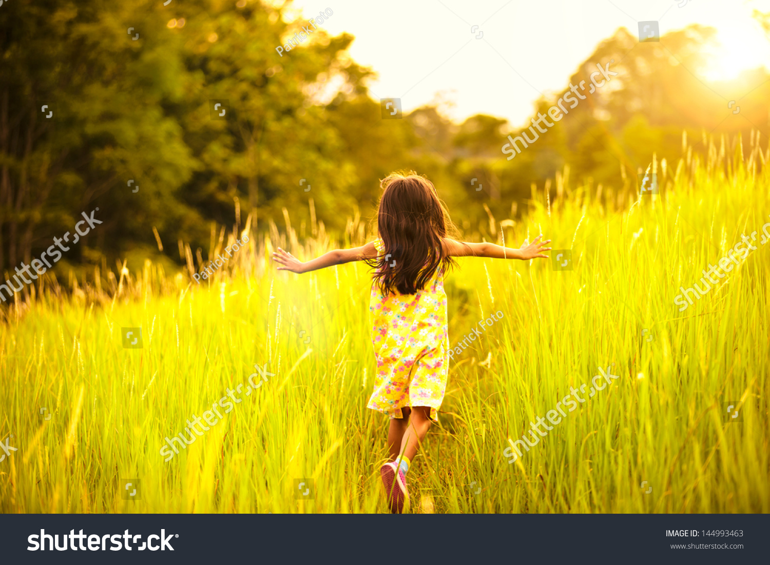 Little Girl Running On Meadow With Sunset Stock Photo   Image Of