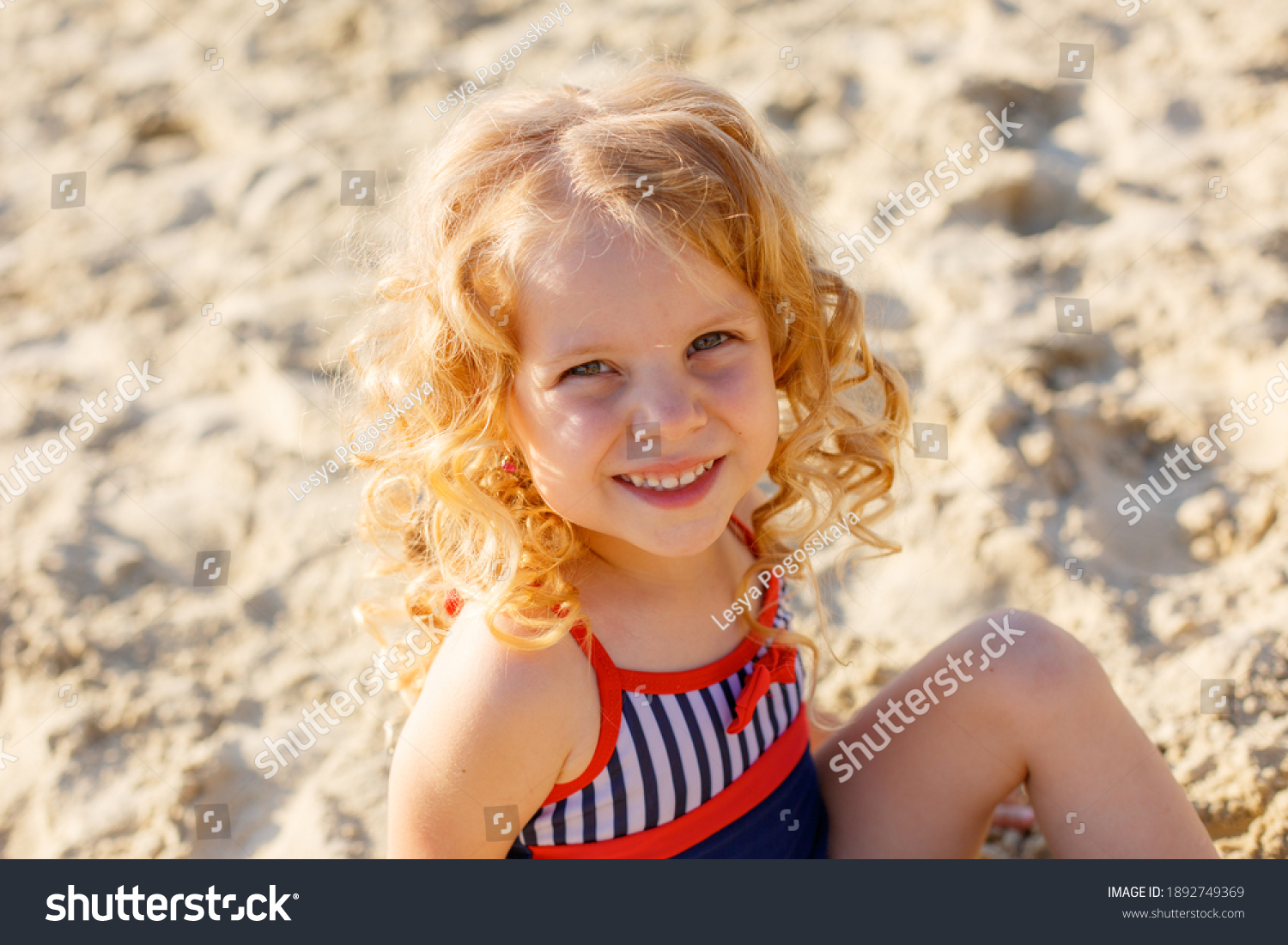Little Girl Sitting On Beach On Stock Photo 1892749369 | Shutterstock