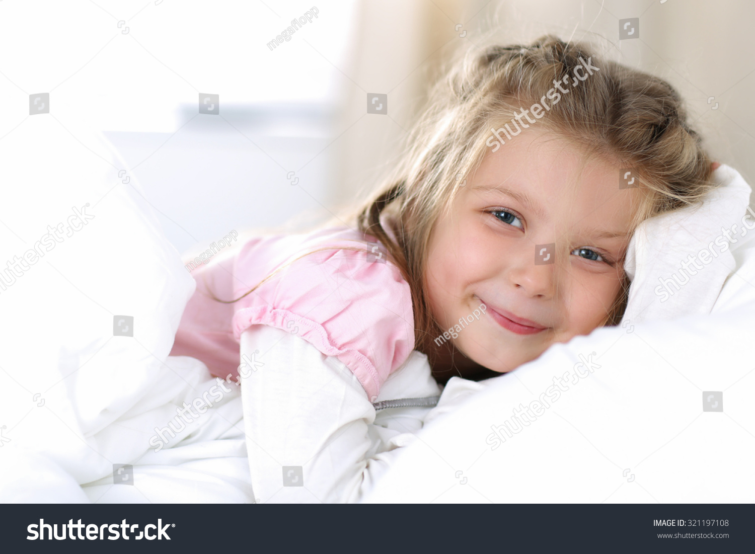 Little Girl Wake Up Early Morning After Sleeping In Her Bed. Smiling ...