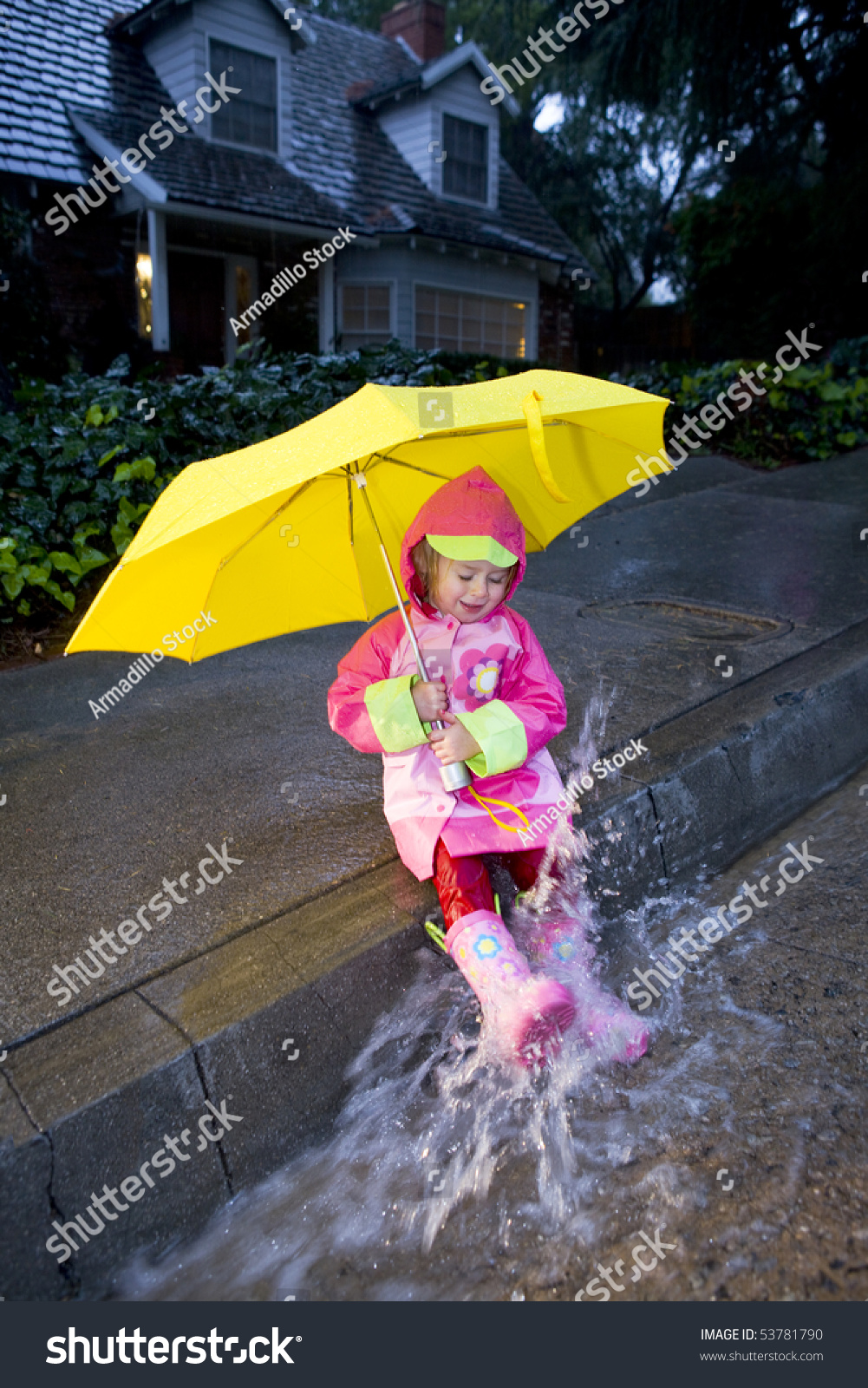 Little Girl With Yellow Umbrella Playing In Rain Wearing Pink Rain ...