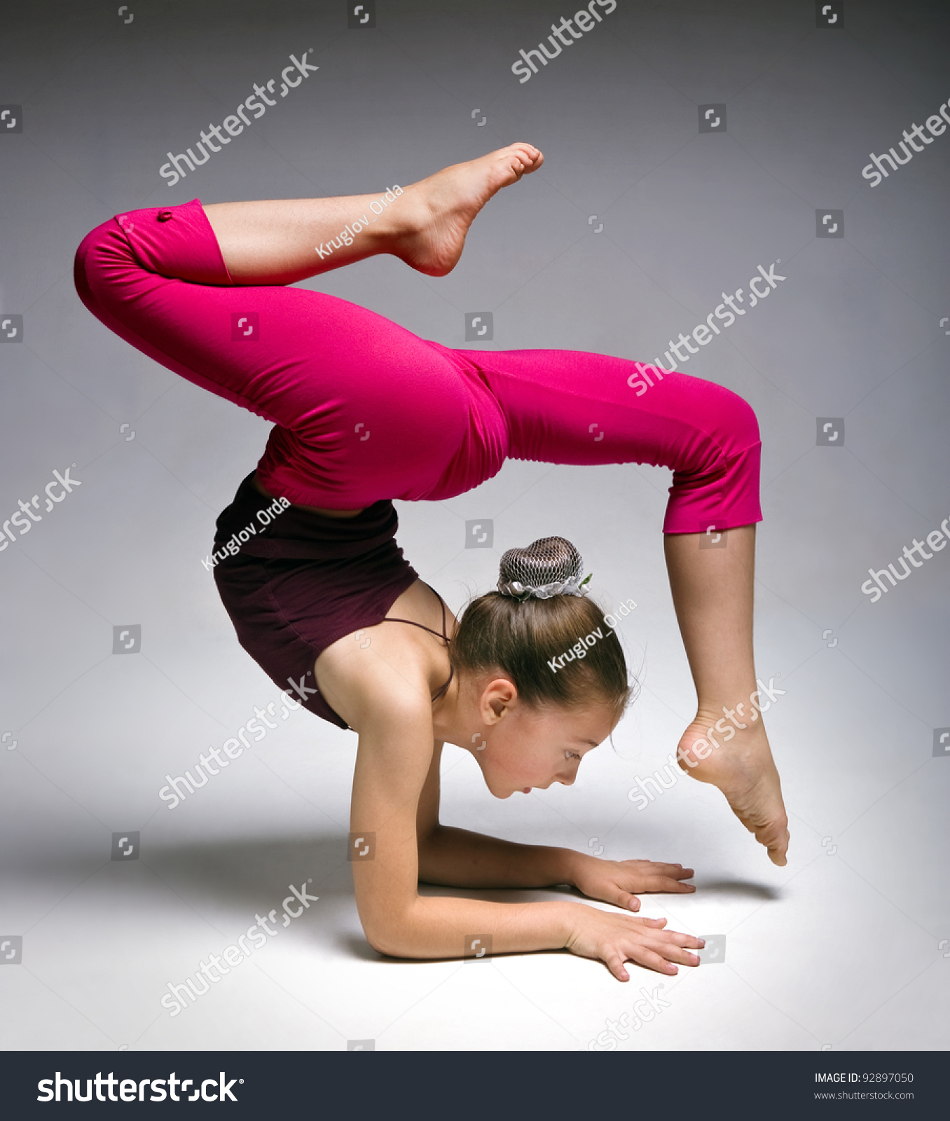 Little Gymnast On A Grey Background.Sporting Exercise Is String.Stretch ...