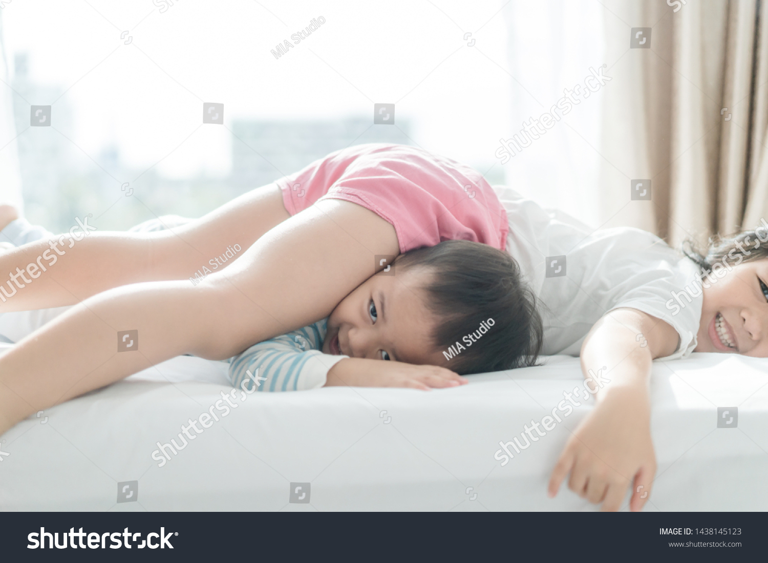 Young Sister On Parents Bed