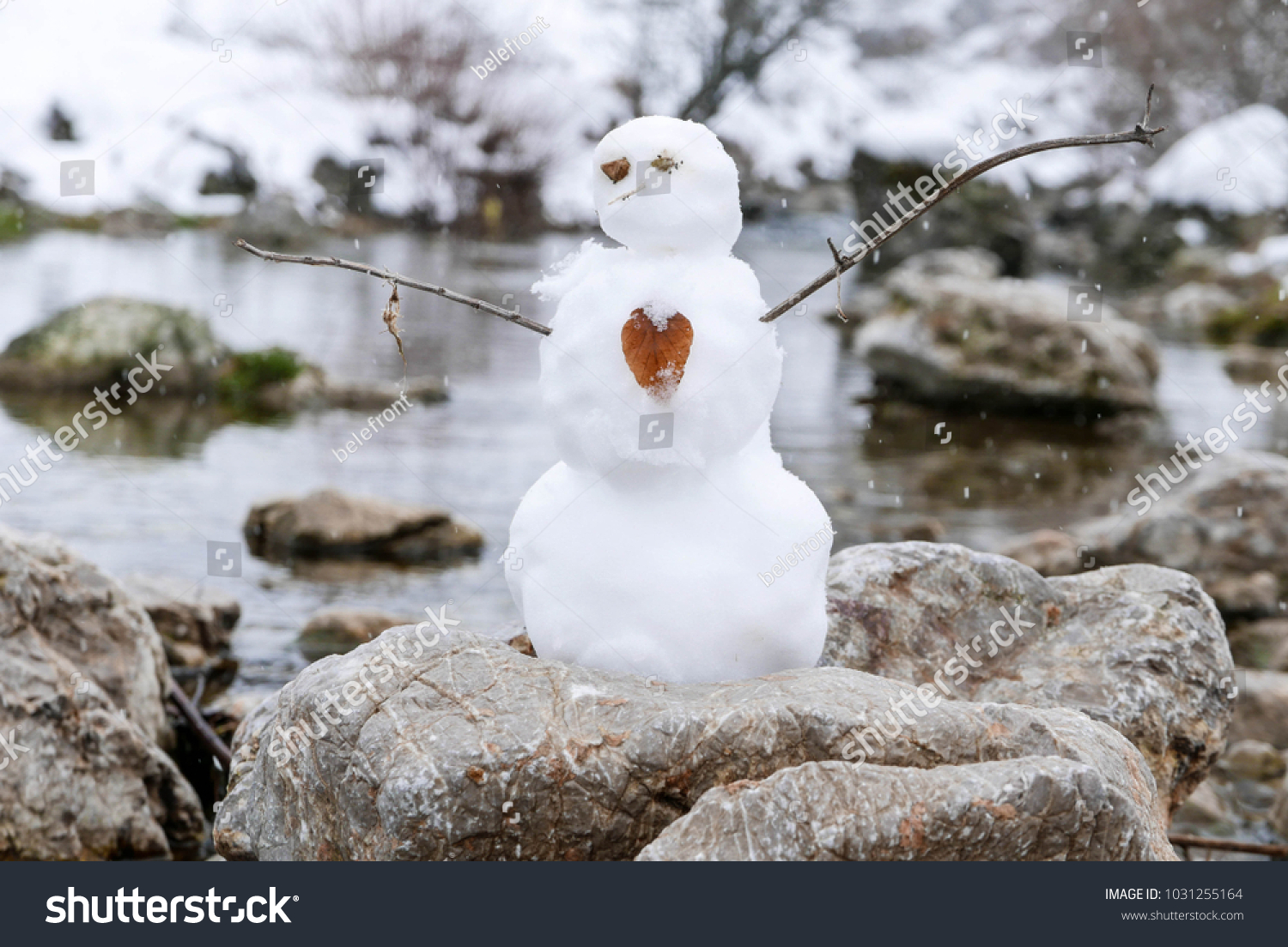 Little Snowman On Rock By River Stock Photo Edit Now