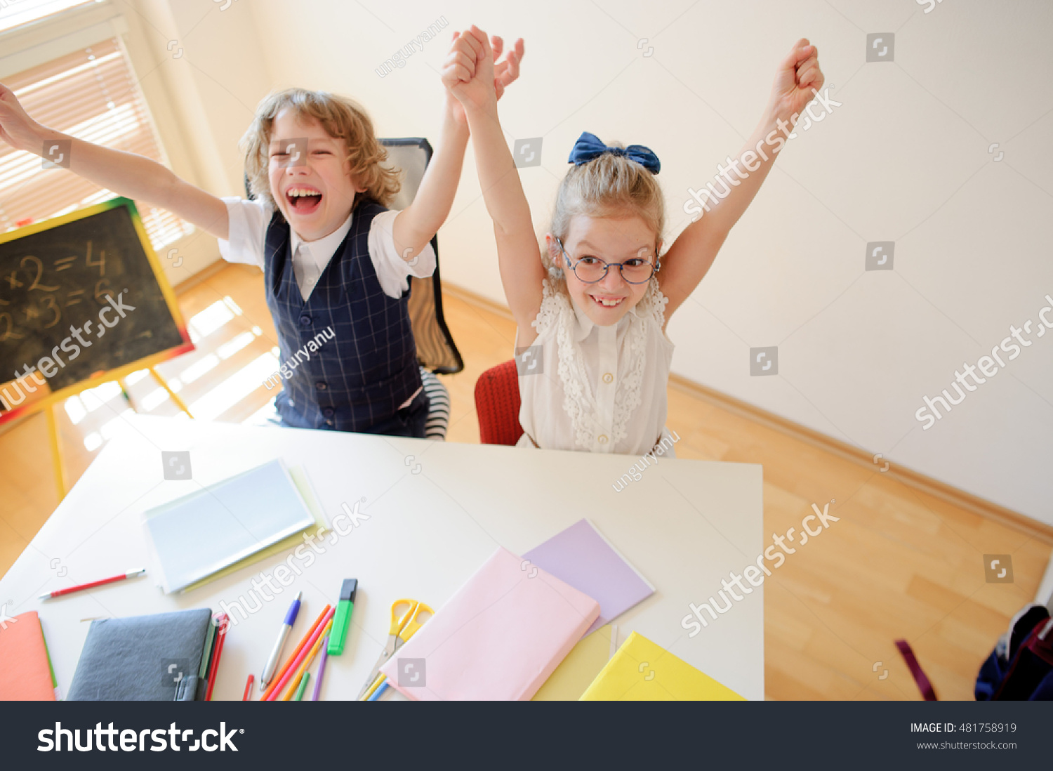 Little Students Doing Exercises While Sitting Stock Photo Edit