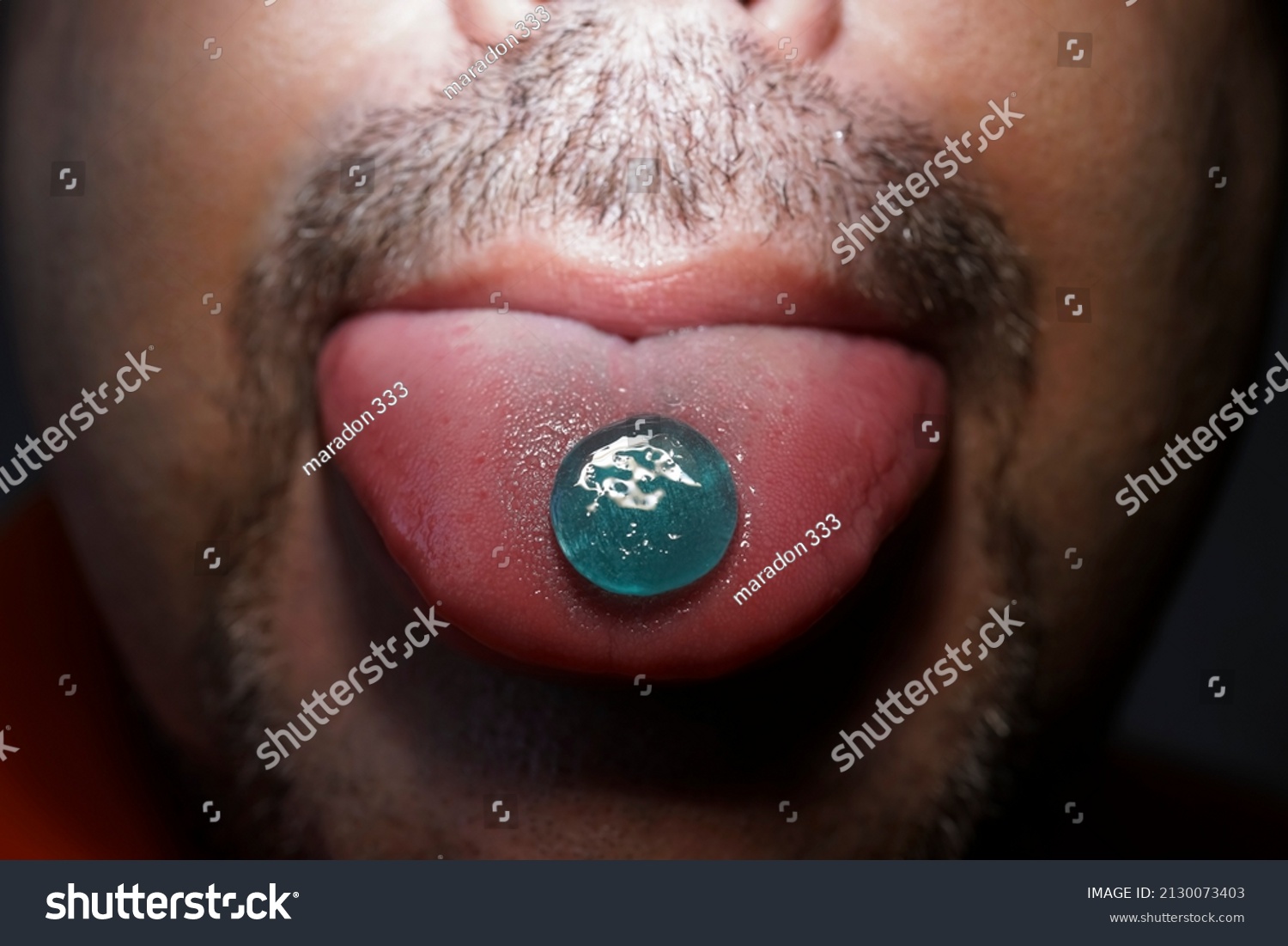 Stock Photo Lollipop From The Throat Which Is On The Tongue Of A Bearded Man Man Eating Pills Cough Sore 2130073403 