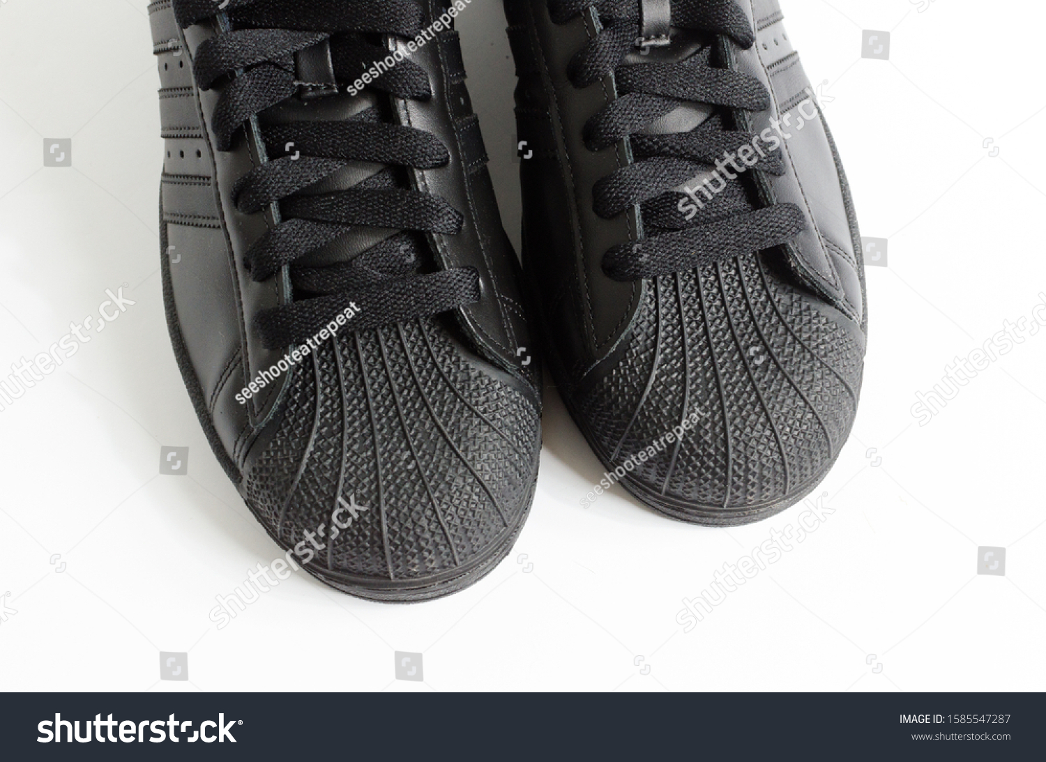 black adidas shell toe trainers