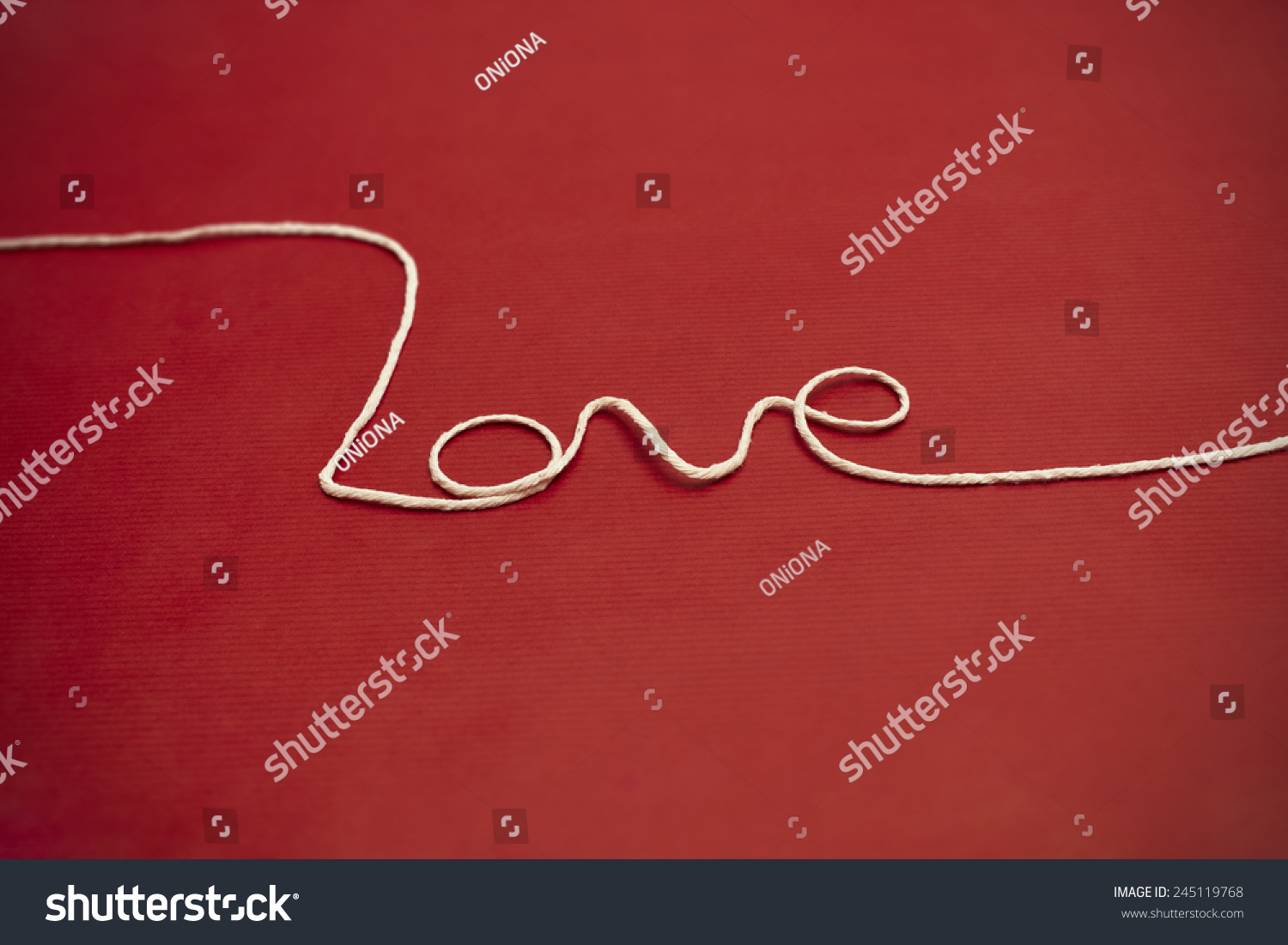 Love Word Made Of White Twine On Red Background For Your Valentine Or Mom Love Word Made Of White Twine On Red Background For Your Valentine Or Mom