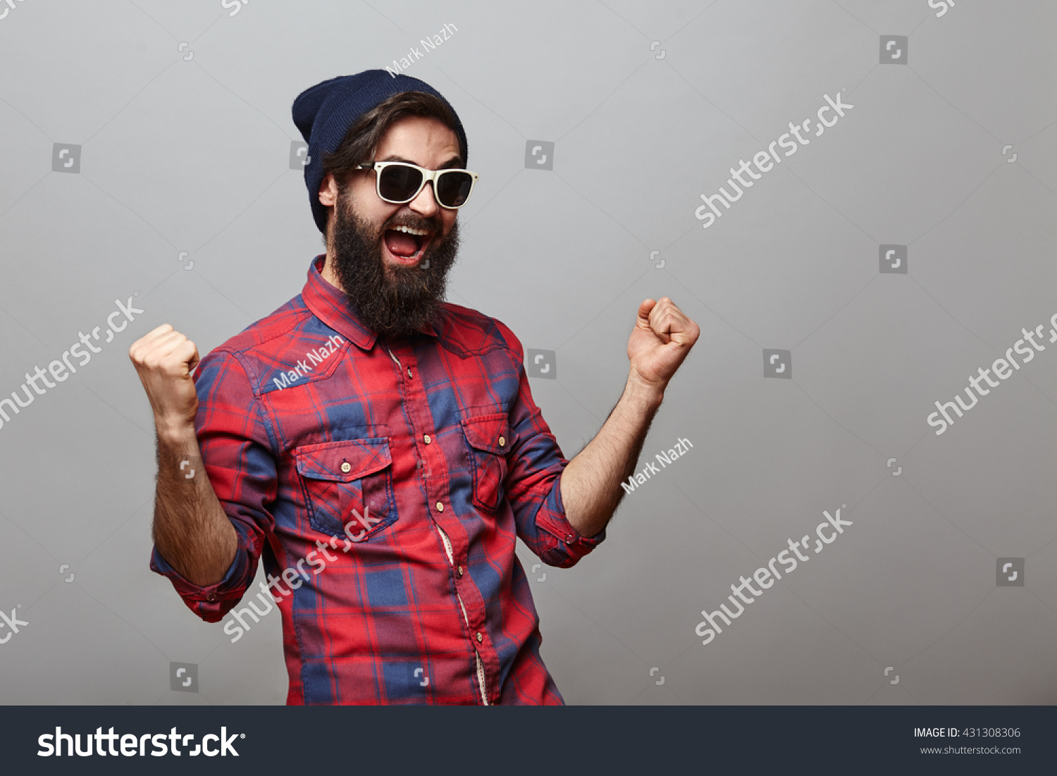 stock-photo-lucky-young-hipster-man-isolated-over-grey-background-bearded-man-wearing-glasses-and-hat-acts-431308306.jpg