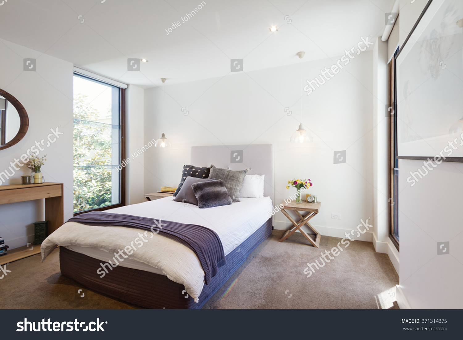 Luxury Interior Designed Bedroom Comfy Pillows Stock Photo ...  Luxury interior designed bedroom with comfy pillows and throw rug and  pendant lights