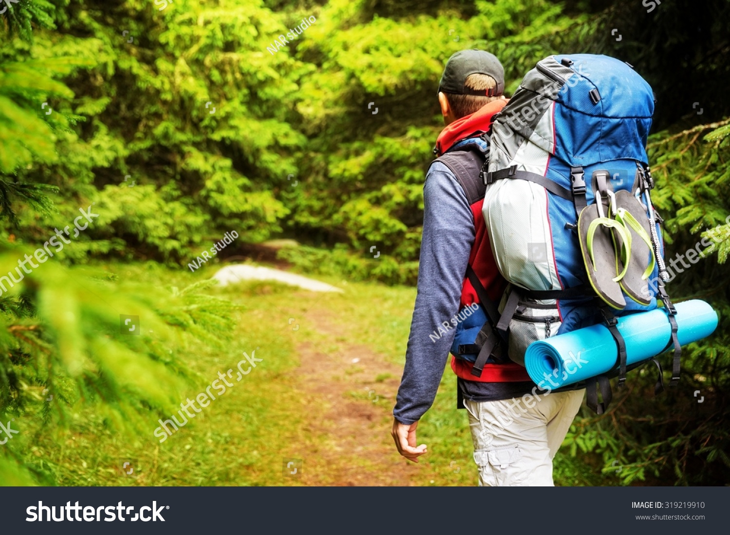 Male Backpacker Hikingtracking Through Mountain Forest Stock Photo 