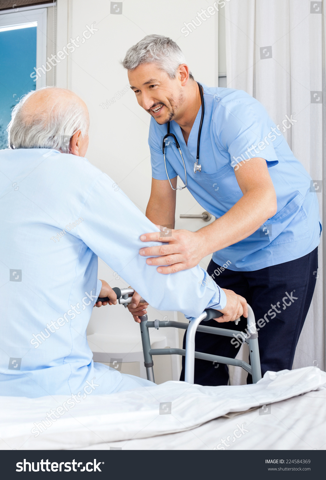 Male Caretaker Assisting Senior Man Use Stock Photo 224584369 ...