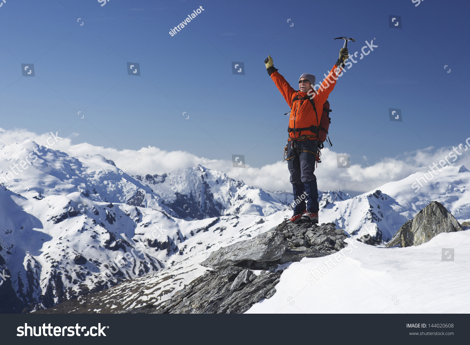 Male Mountain Climber Raising Hands With Icepick On Top Of Snowy Peak ...