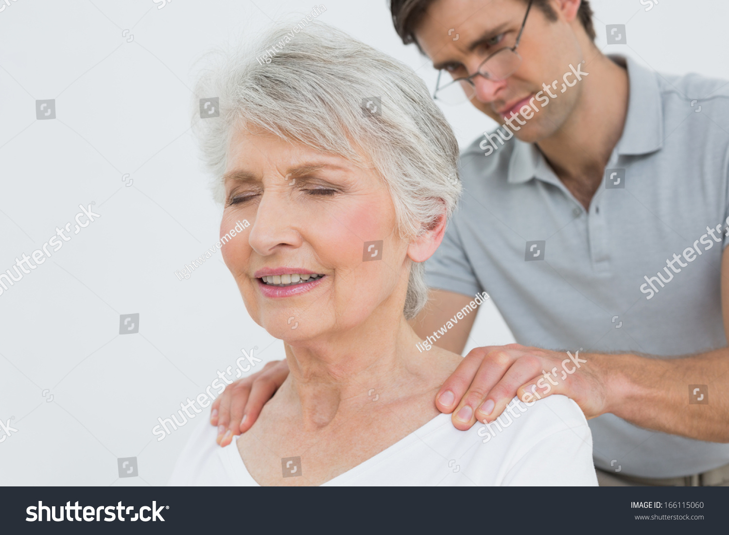 Male Physiotherapist Massaging Senior Womans Neck Stock Photo 166115060