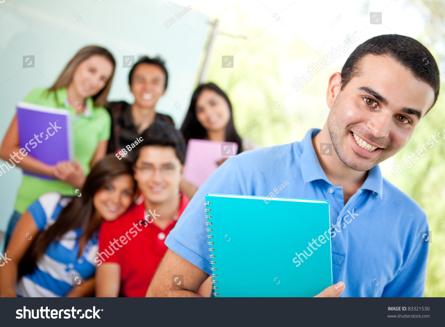 Male Student At The University With A Group Of People Behind Stock ...