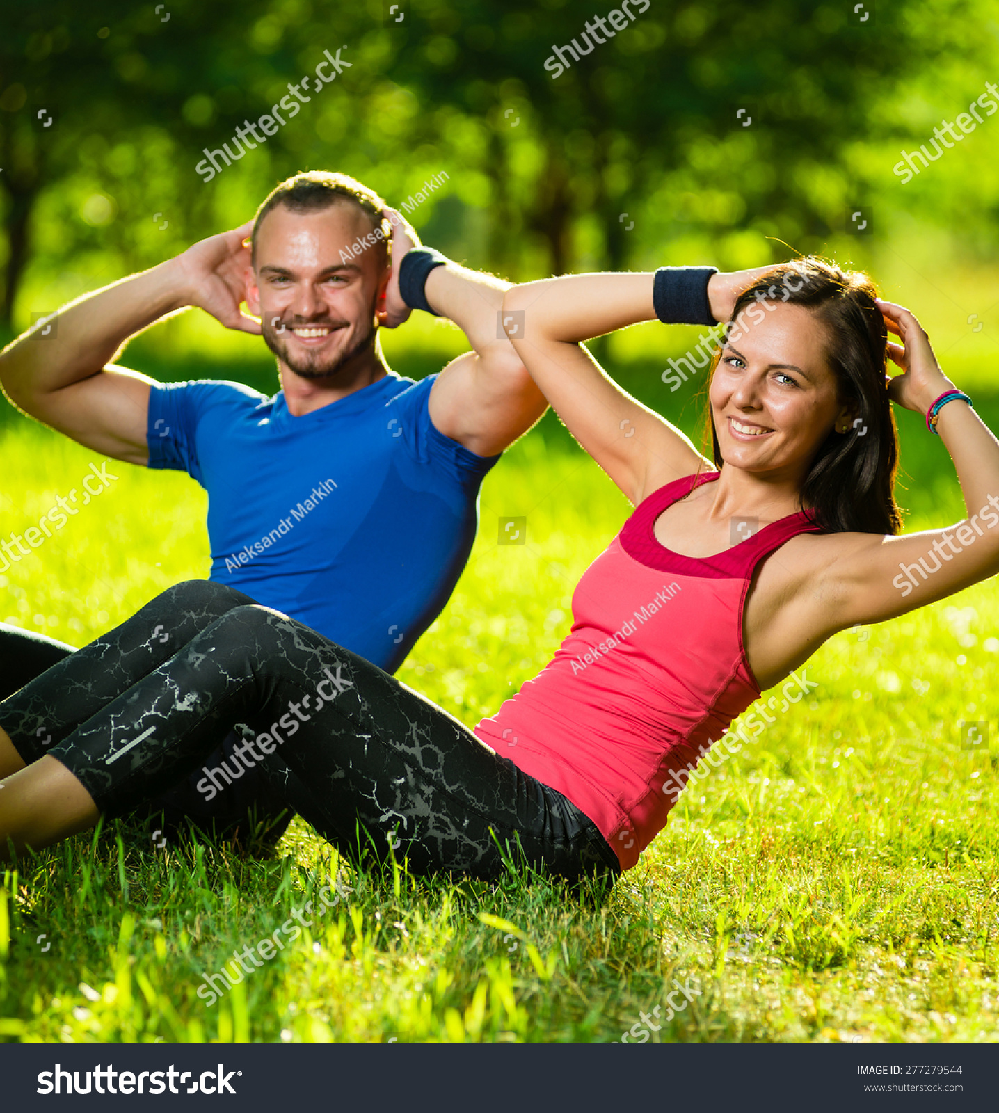 Man And Woman Exercising At The City Park. Beautiful Young Multiracial ...