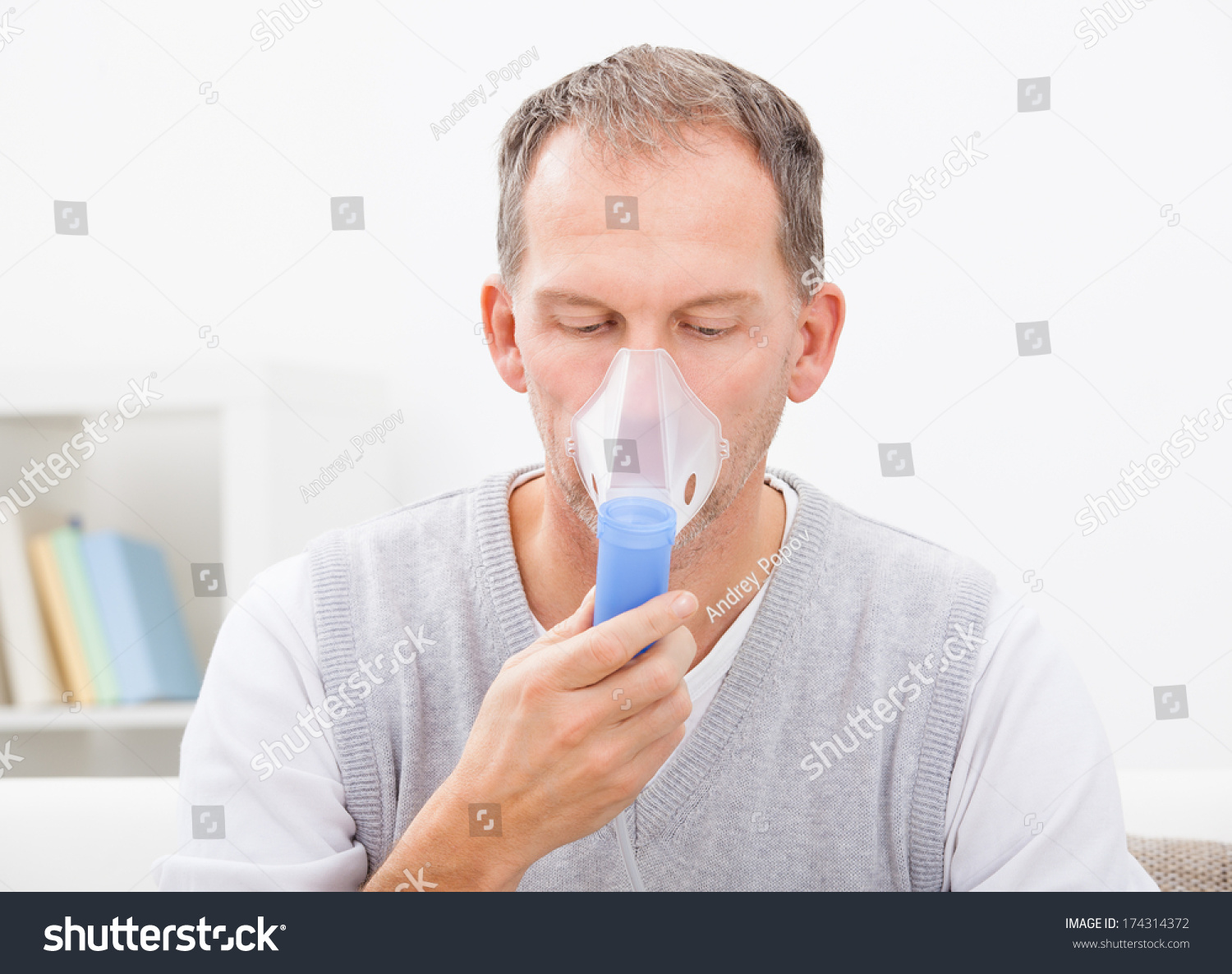 Man Doing Inhalation Through Oxygen Mask At Home Stock Photo 174314372 ...