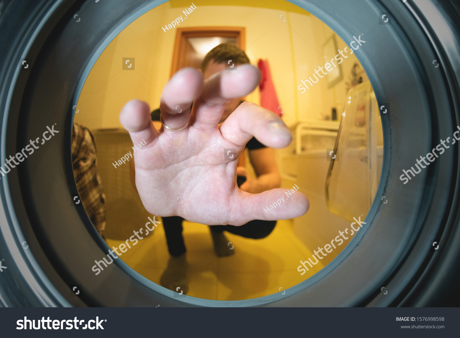 man-hand-put-dirty-clothes-washing-stock-photo-1576998598-shutterstock