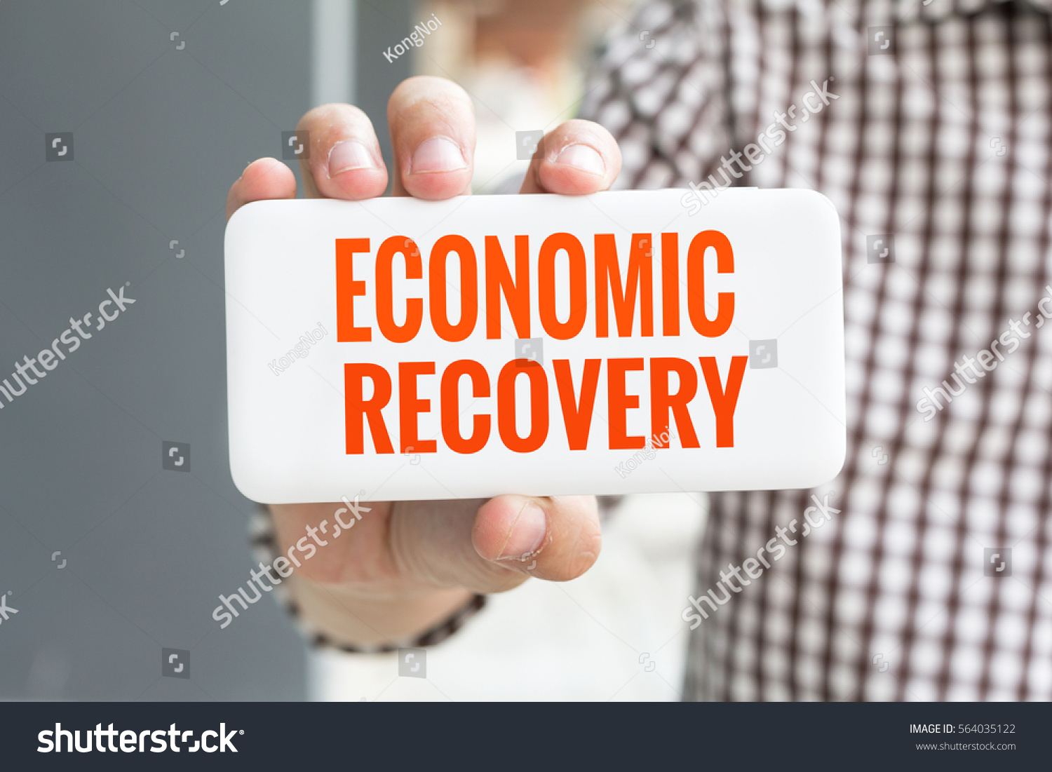 man-hand-showing-economic-recovery-word-stock-photo-564035122