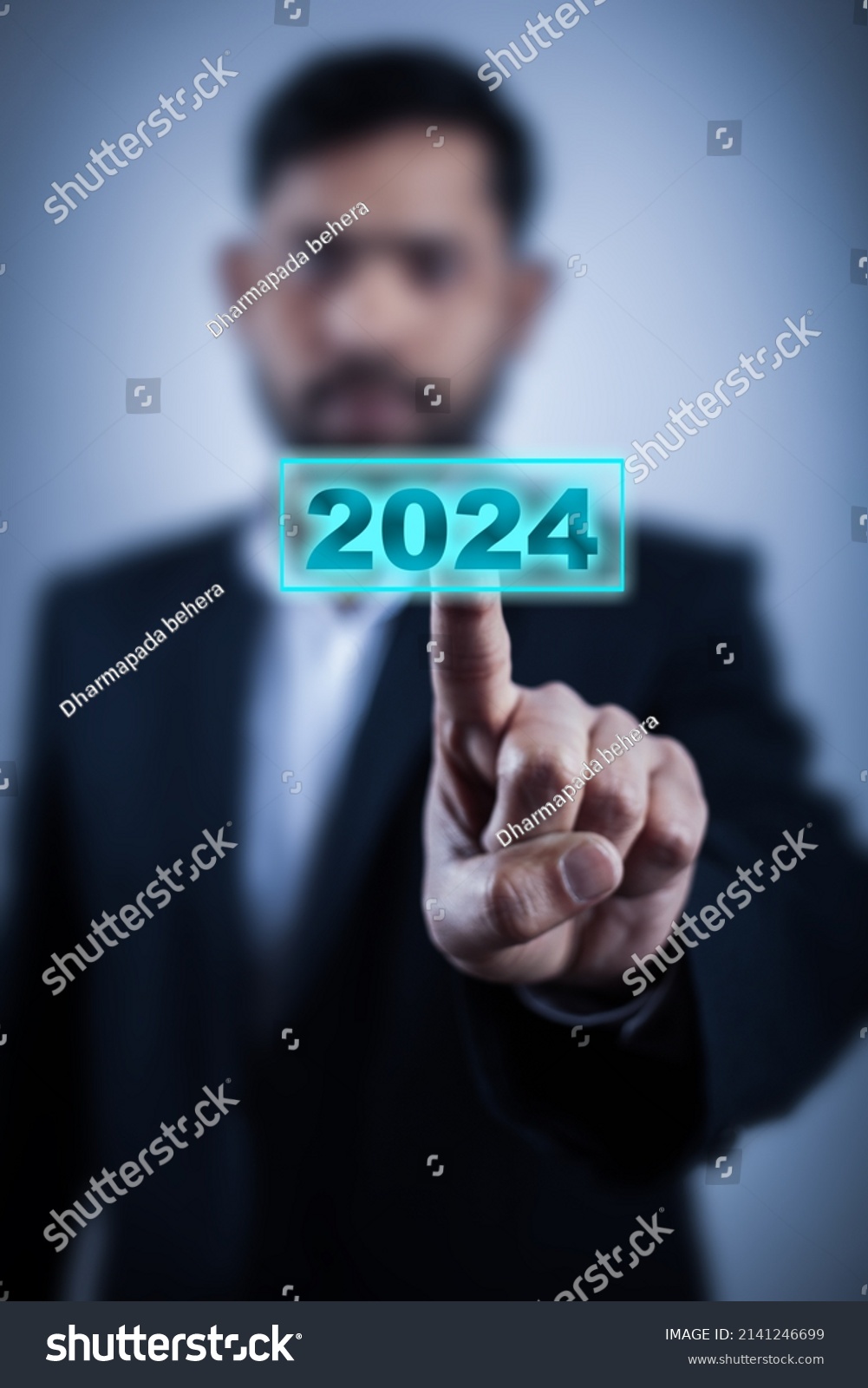 Stock Photo Man Hand Touching On Year Button On Virtual Screen In High Tech Background 2141246699 