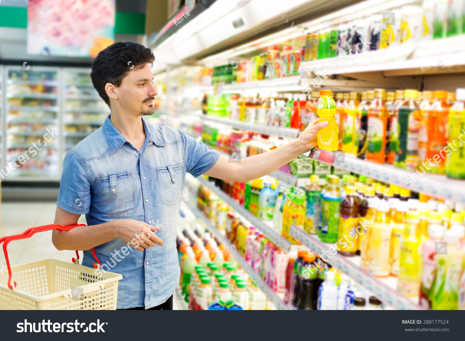Man In A Supermarket Buying A Bottle Of Juice Stock Photo 288177524 ...