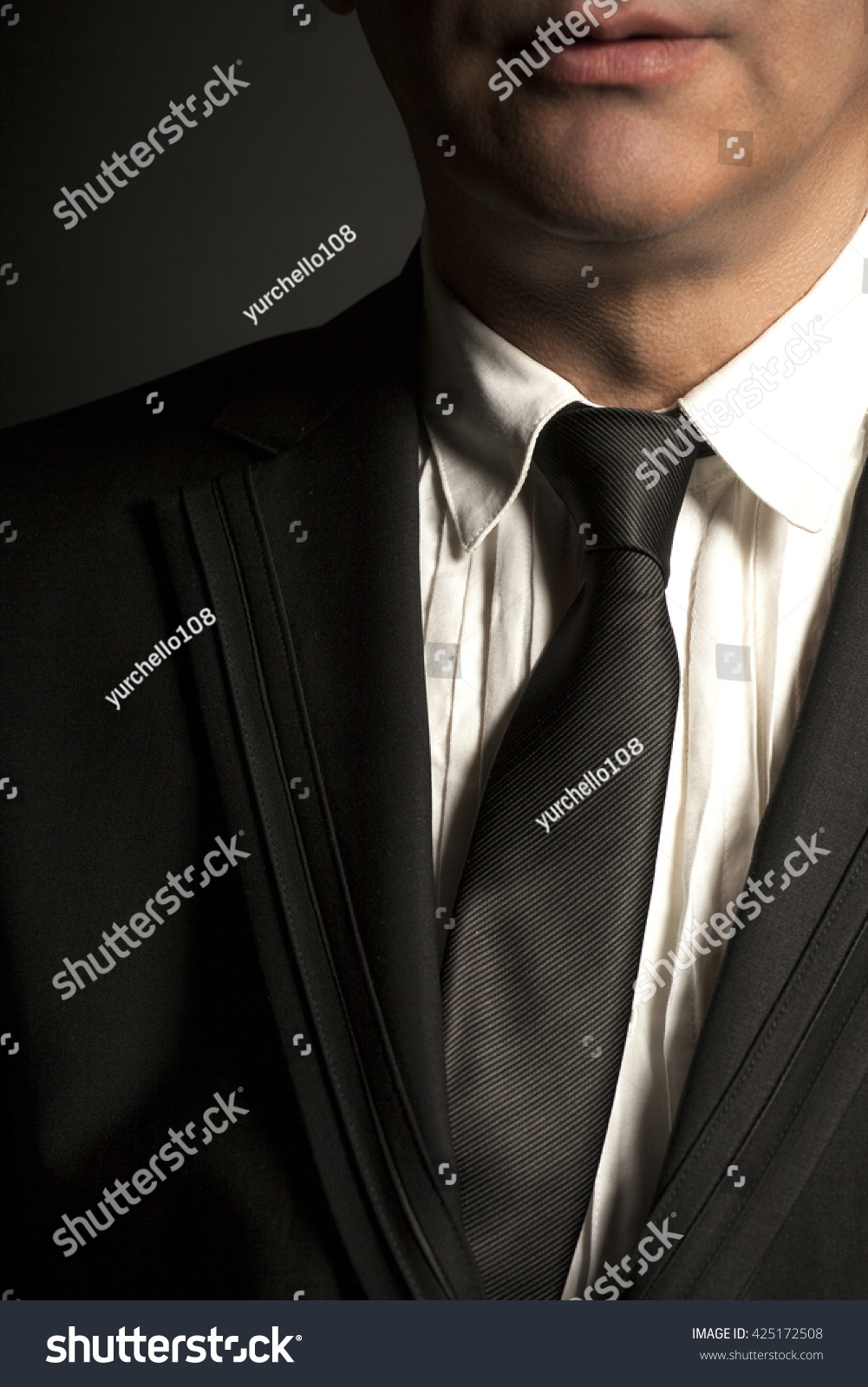 Man In Black Suit And Black Tie On A Black Background Stock Photo ...