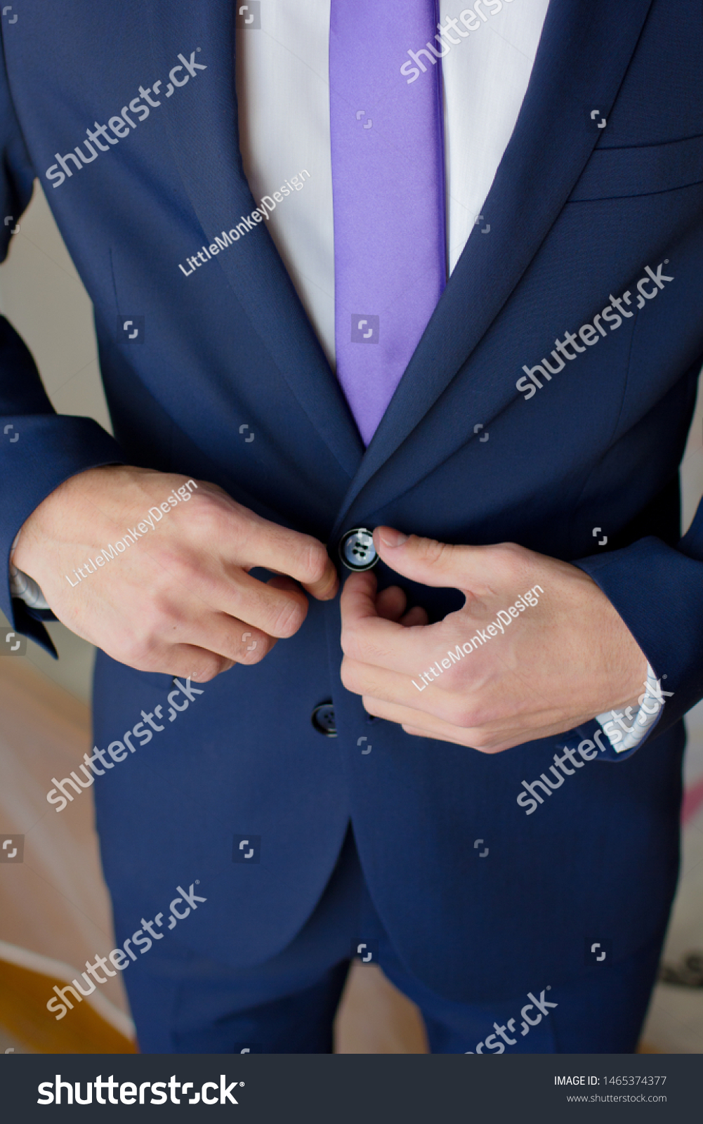 suit and purple tie