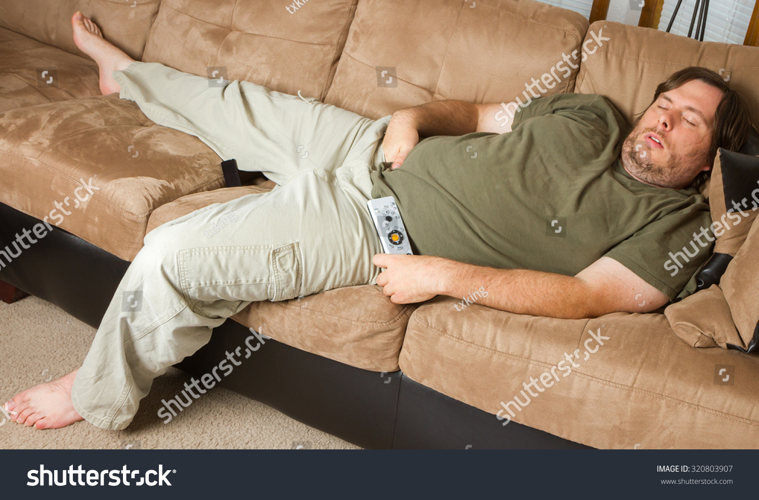 Man Mat Falls Asleep On The Couch With His Hands Down His Pants Stock ...