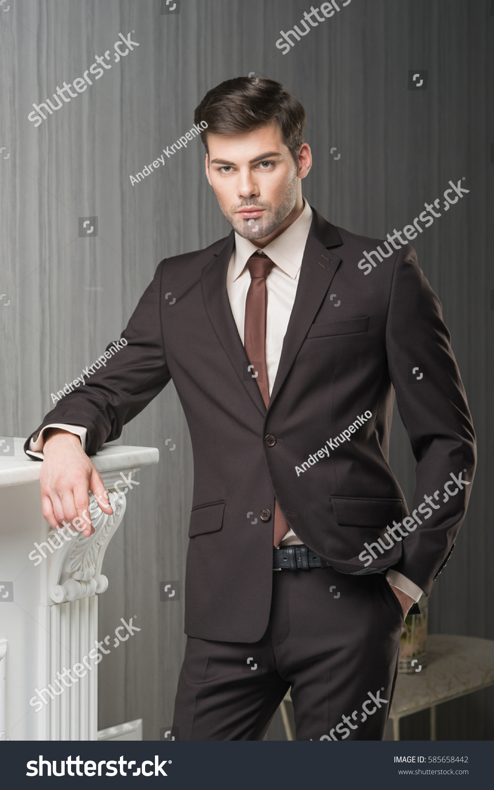 black suit and brown tie