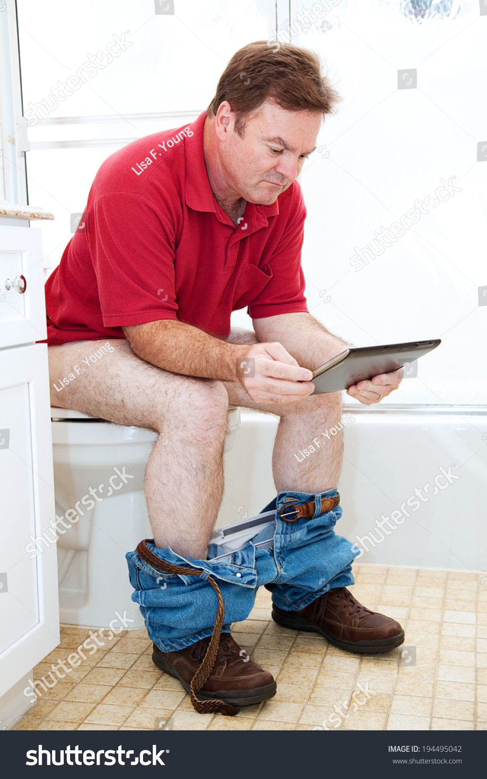 Mature Man On The Toilet Reading Newspaper Stock Photo 