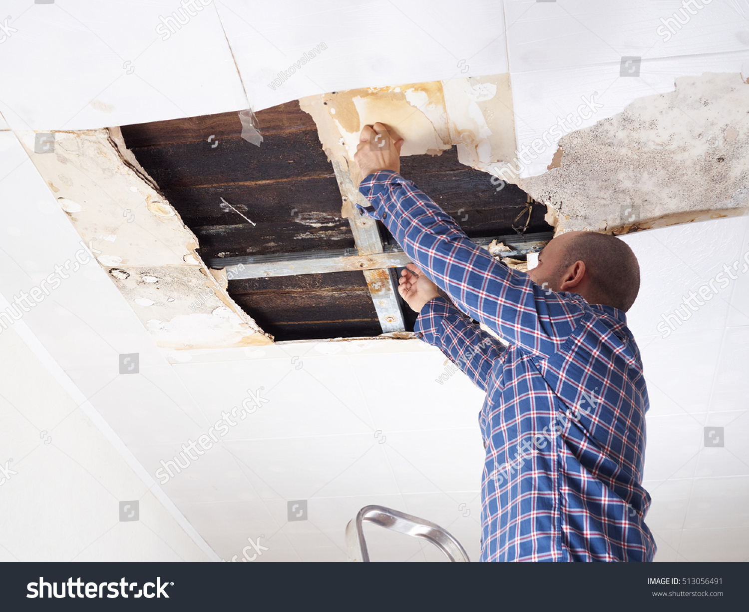 Man Repairing Collapsed Ceiling Ceiling Panels Stock Photo