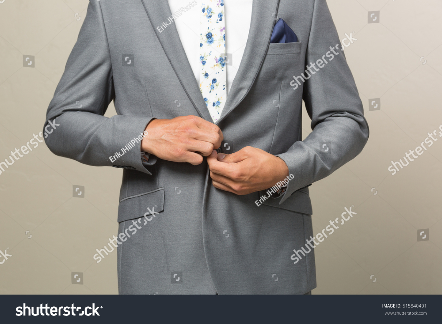 grey suit with brown belt