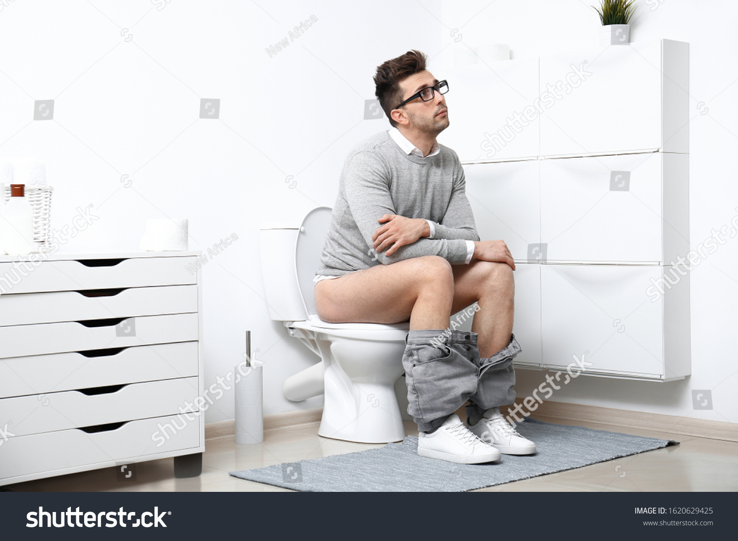 Man Glasses Sitting On Toilet Bowl Stock Photo (Edit Now) 1620629425