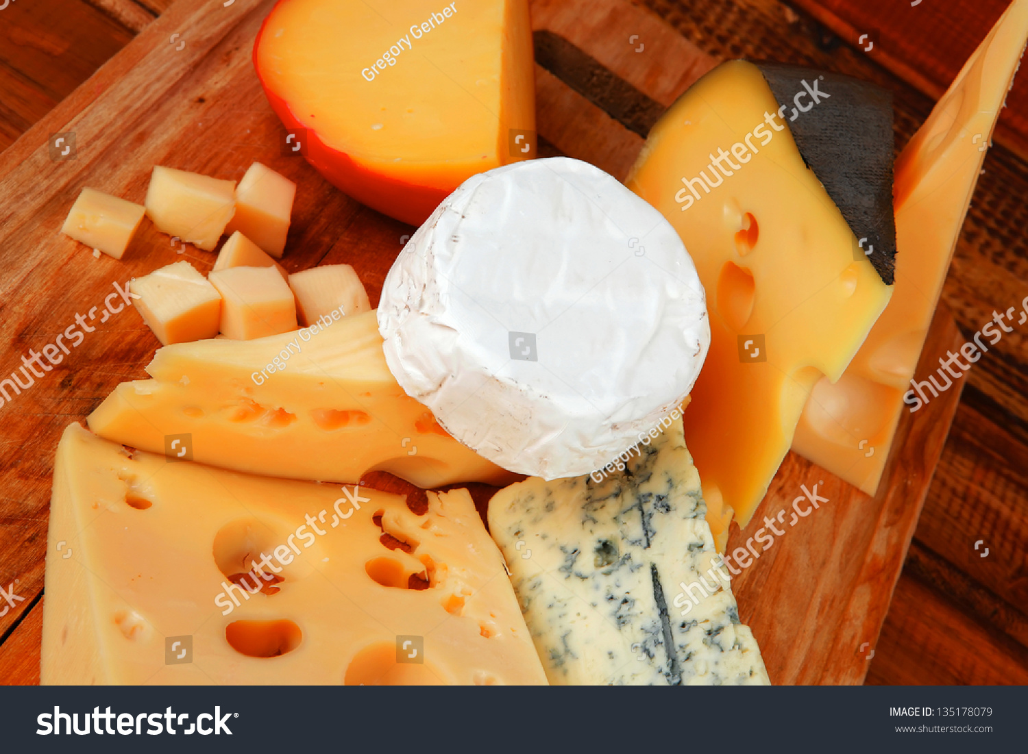 Many Delicious Aged Cheeses On Wooden Plate Stock Photo 135178079 ...