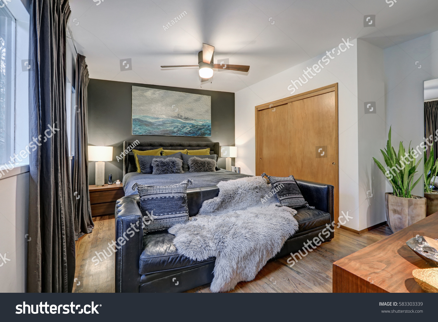 Masculine Bedroom Features Gray Accent Wall Stock Photo