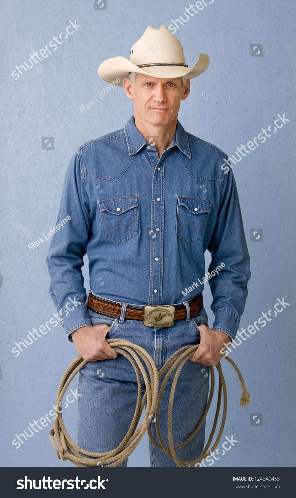 Mature Cowboy Against Blue Background 