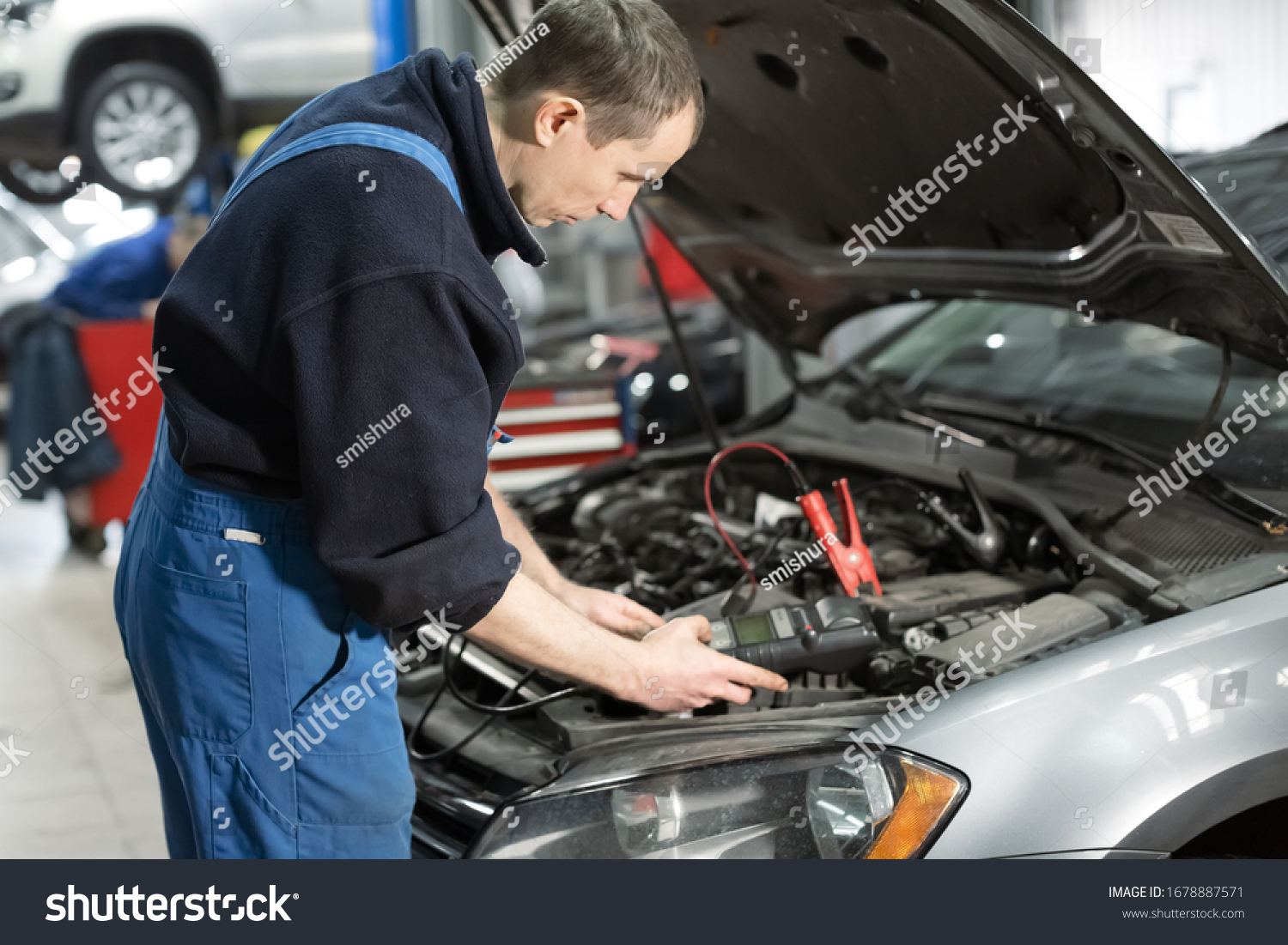 Mechanic Examining Under Hood Car Repair Stock Photo (Edit Now) 1678887571