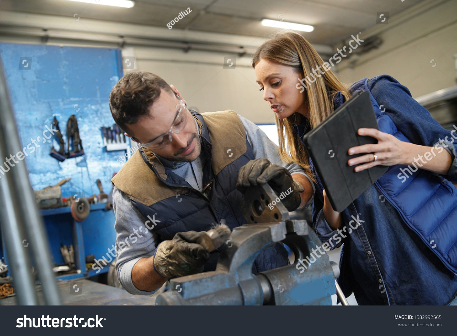 mechanical-workshop-manager-giving-instructions-employee-stock-photo