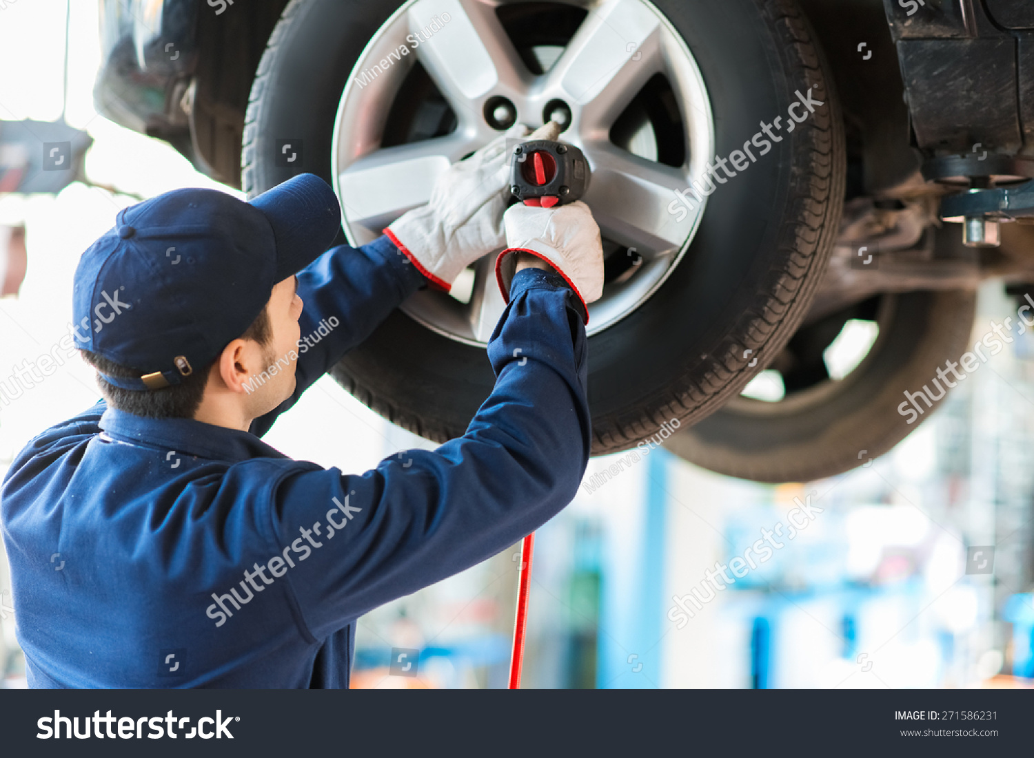 Mechanician Changing Car Wheel Auto Repair Stock Photo (Edit Now) 271586231 - Stock Photo Mechanician Changing Car Wheel In Auto Repair Shop 271586231