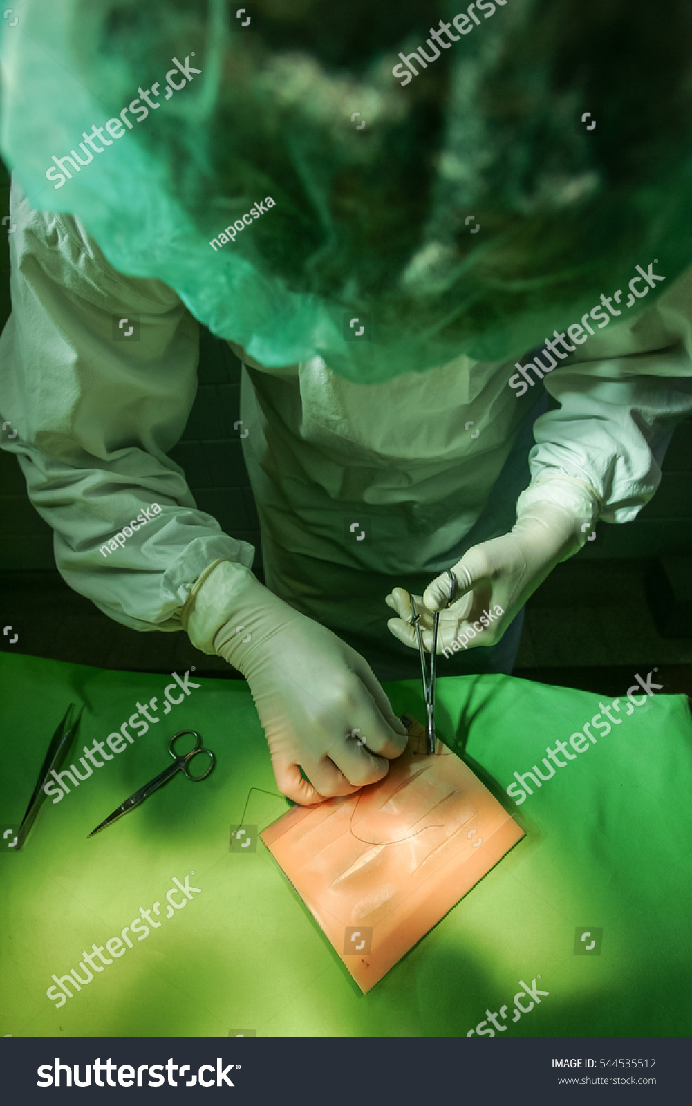 Medical School Student Practicing Surgical Stitching On A Piece Of ...