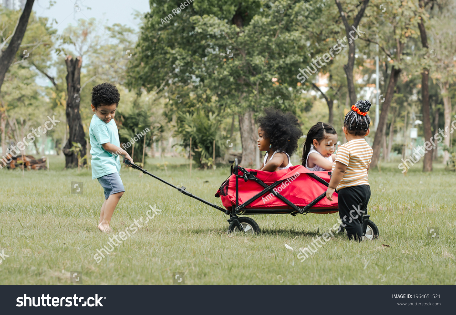 2 652 Child Red Wagon Images Stock Photos Vectors Shutterstock   Stock Photo Mixed Race Little Cute Children Pull And Drag A Red Cart While Playing In Outdoor Green Park 1964651521 