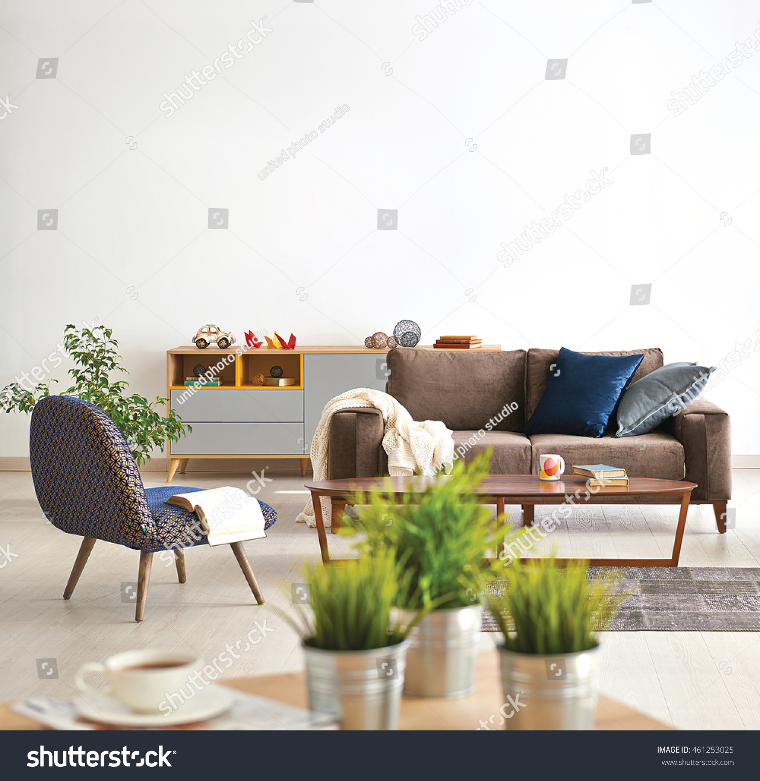 Modern Living Room Sofa And Armchair With Vase Of Grass Stock Photo